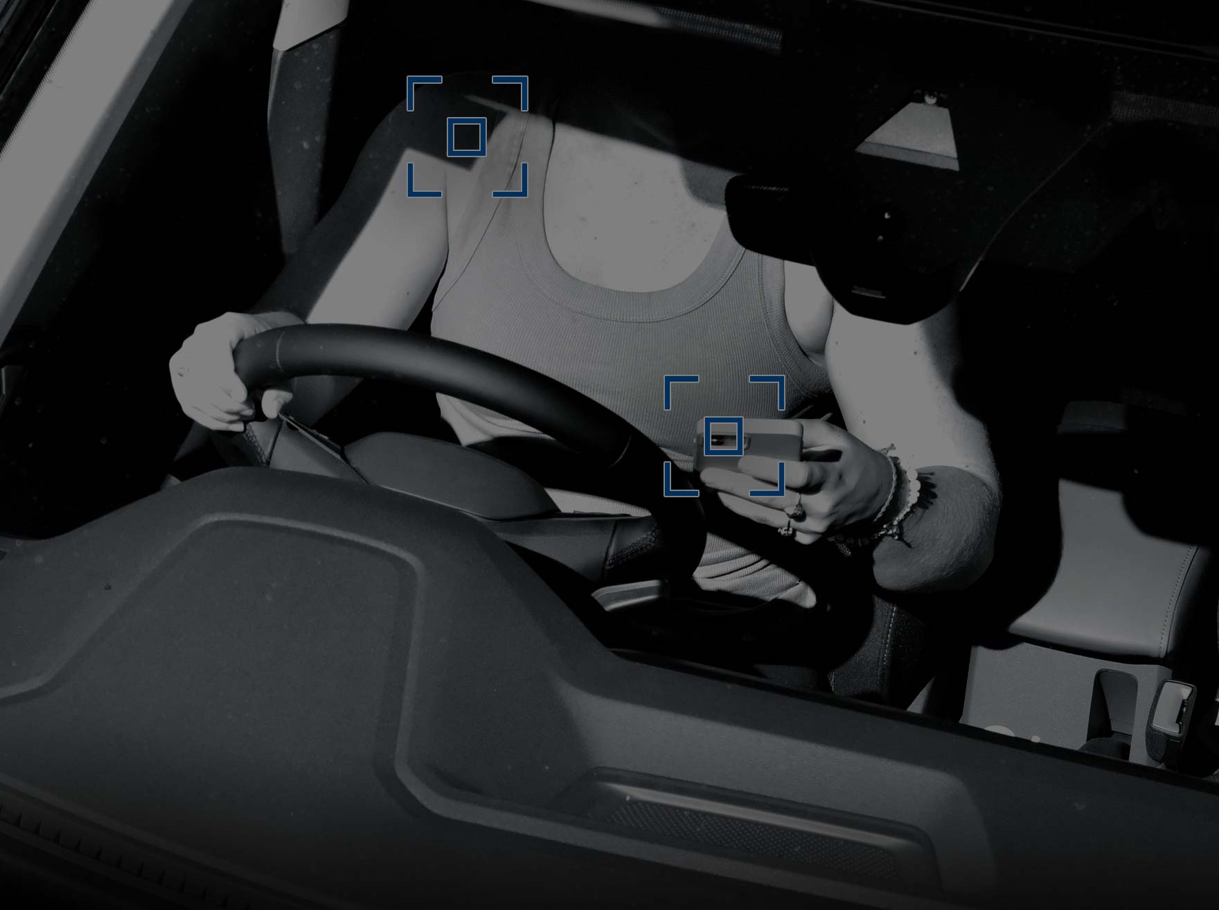 rad camera photo of driver without seatbelt looking at mobile